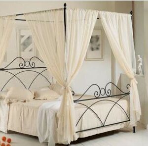 Classic colonial dark wood four-poster bed for luxury rental.